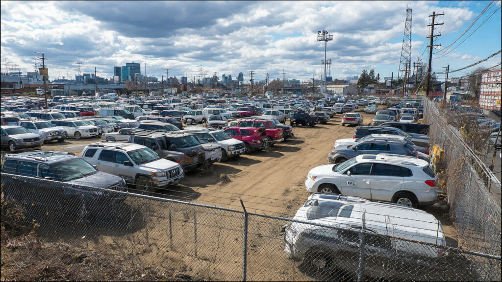 Simple Guide To Searching For Police Impound Car Auctions Near You A rows of police impound cars parked in a lot during a public auction event.